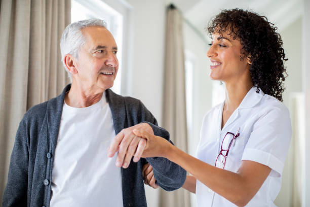 istock Smiling nurse and patient walking in corridor 1059640472