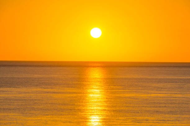 The beautiful sunsets of Paphos, Cyprus, setting on the horizon of the ocean waters of the Mediterranean.