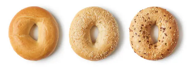 Photo of Fresh bagels on white background, from above