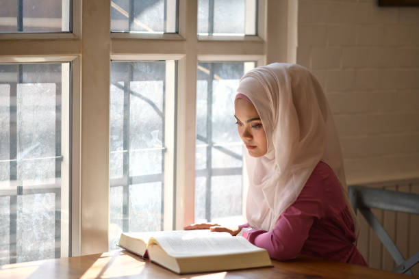 istock Young Asian Muslim reading a book. 1059647914