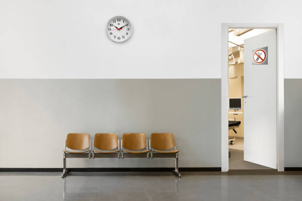 waiting room empty waiting room with chairs, clock on wall and open door with phone off symbol waiting room stock pictures, royalty-free photos & images
