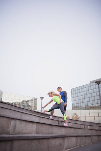 istock Young couple, athletes, training outdoors in the urban environment 1059648154