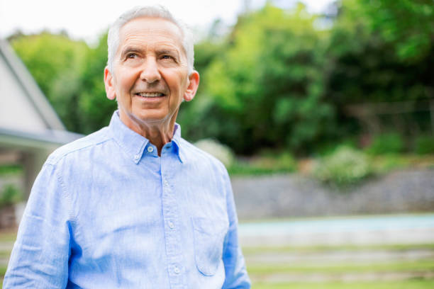 istock Thoughtful retired man looking away in back yard 1059649272
