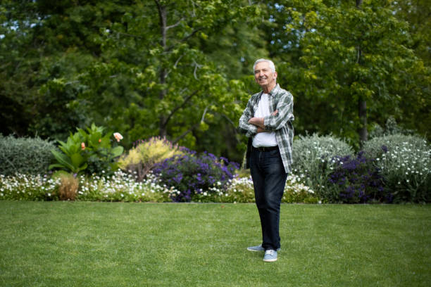 Retired senior man standing with arms crossed