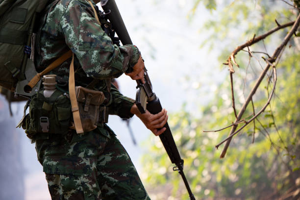 istock Midsection Of Army Soldier Holding Rifle 1059654336