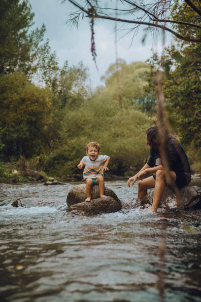 istock Boy playing in the river with his father 1059654958