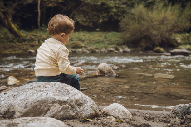 istock Portrait of a toddler by a river 1059654986