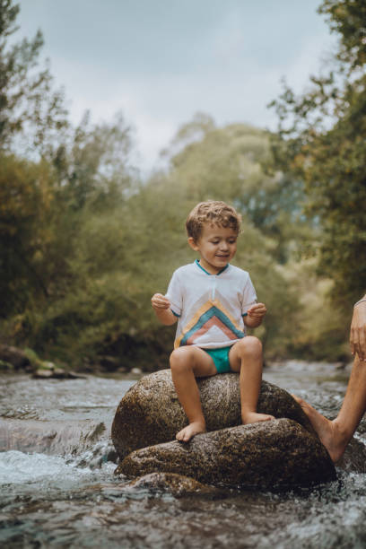 istock Boy playing in the river with his father 1059655236