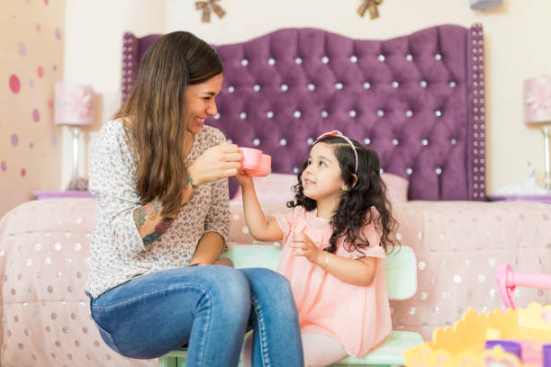 young woman and preschooler playing with toy kitchen set - preschooler child playing latin american and hispanic ethnicity imagens e fotografias de stock