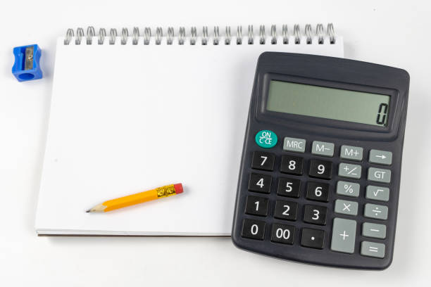 istock Notebook for taking notes and pencil on the office table. Accessories for quotation and memorization needed in accounting. White background. 1059658476