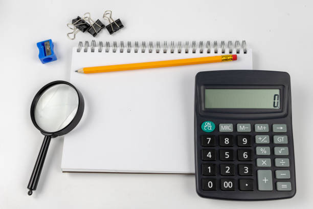 istock Notebook for taking notes and pencil on the office table. Accessories for quotation and memorization needed in accounting. White background. 1059662350