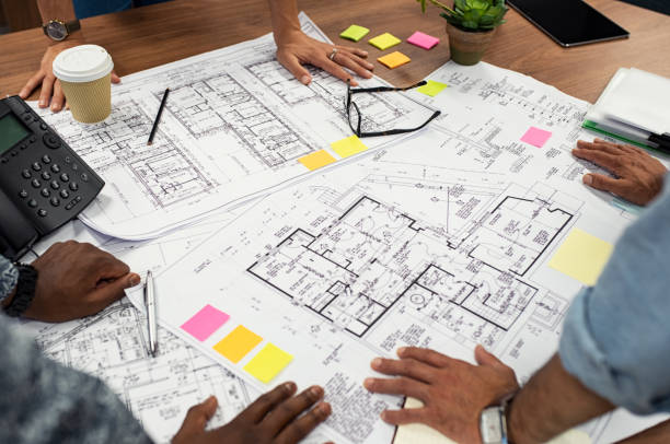 architects working on blueprints - schematic drawing imagens e fotografias de stock