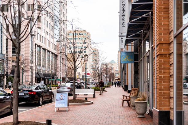 Town center building architecture, sidewalk, Market street road during day, restaurants in northern Virginia, people Reston, USA - April 11, 2018: Town center building architecture, sidewalk, Market street road during day, restaurants in northern Virginia, people fairfax virginia photos stock pictures, royalty-free photos & images