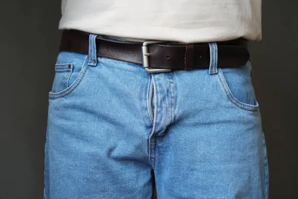 midsection of man dressed in jeans with open fly
