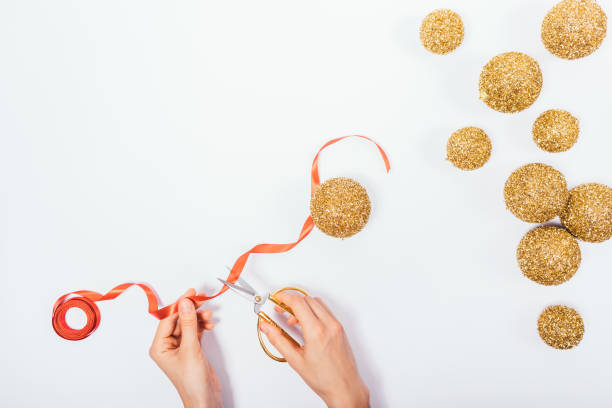 istock Female's hands cut red ribbon with decorative scissors 1059674376