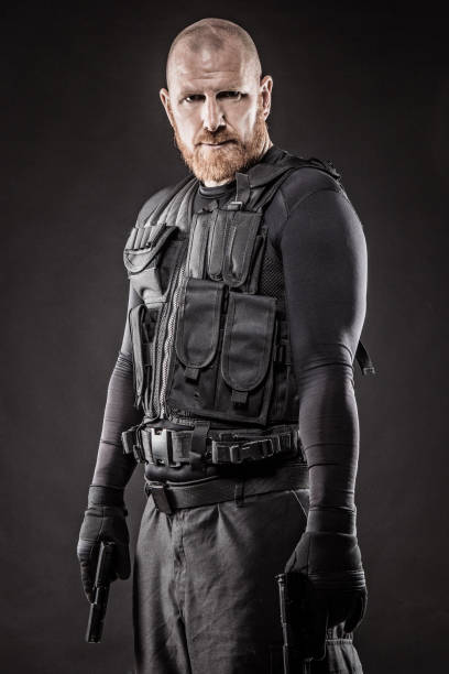 Macho redhead male military swat security anti terror member Macho shaven headed redhead male military swat security anti terror member cosplay event stock pictures, royalty-free photos & images