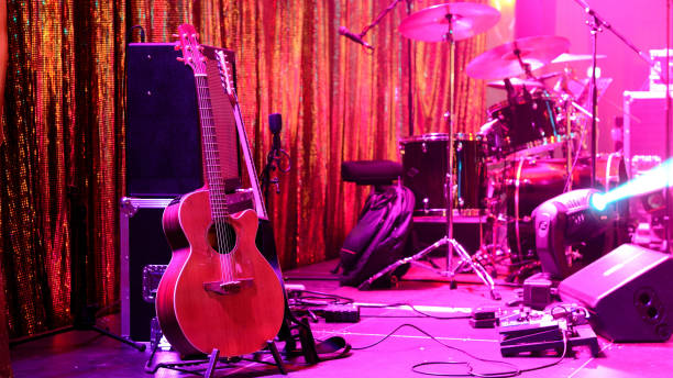 istock Guitar and other musical equipment on stage before concert 1059676268