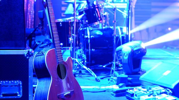 istock Guitar and other musical equipment on stage before concert 1059676278