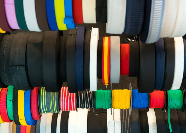 istock Colourful embroidery thread spool using in garment industry, row of multicoloured yarn rolls, sewing material selling in the market 1059678418