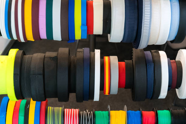 istock Colourful embroidery thread spool using in garment industry, row of multicoloured yarn rolls, sewing material selling in the market 1059678506