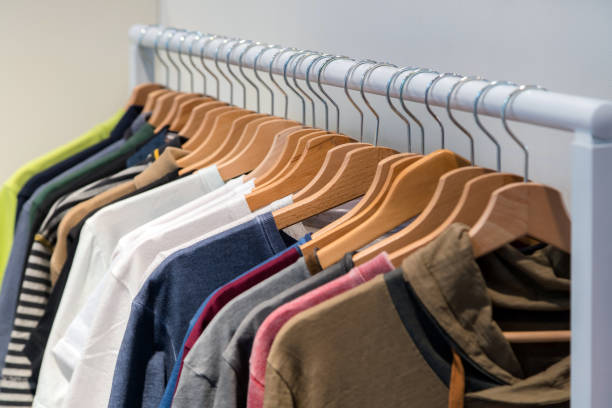 istock Designer shirts on display in a retail store. Different colour and texture shirts hanging on a hanger 1059678830