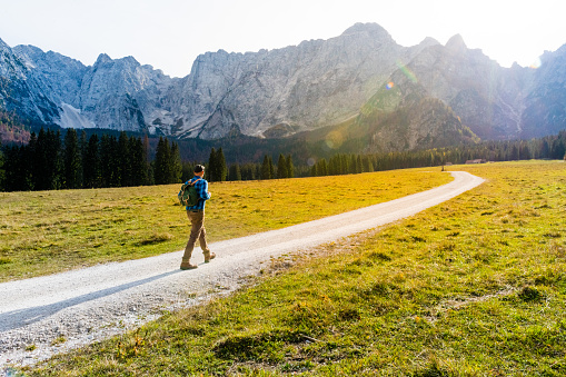 Young Adult Man Hiking In Autumn, Julian Alps, Lagi di Fusine Forest, Italy, Europe.