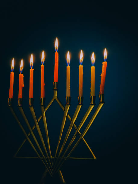 istock Nine burning candles on dark blurred background, close-up. Hanukkah concept 1059689714