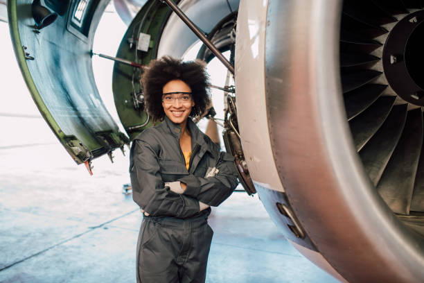 istock Happy woman standing by airplane engine 1059697356