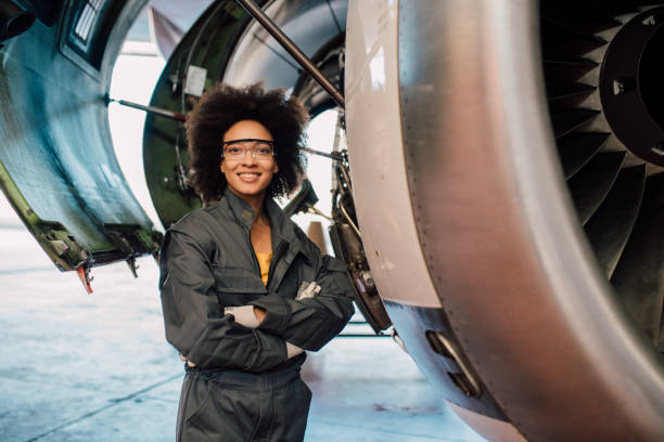istock Young woman working at airplane hangar 1059697364