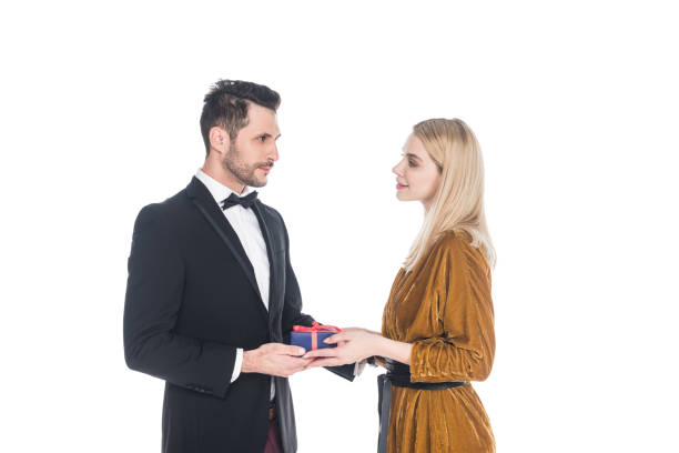 istock young man presenting wrapped gift to beautiful girlfriend isolated on white 1059700220
