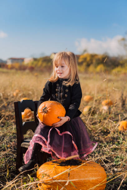 istock Child playing in the pumpkin field on Halloween 1059703820