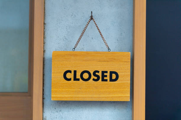 istock Closed sign board hanging on the  wall 1059704766