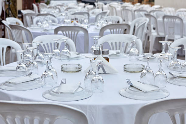 istock Plastic tables setting for an outdoor reception. 1059705858