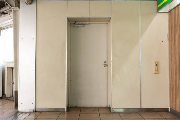 istock sidewalk by street wall & door 1059706970