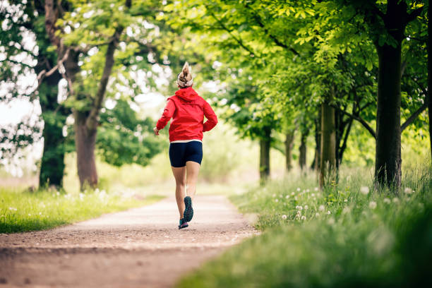 istock Running woman, enjoying summer day in park 1059707938