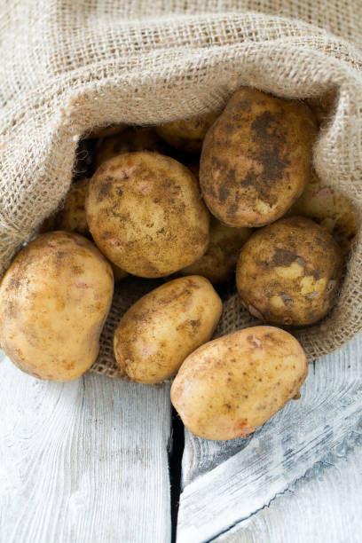 istock potatoes on wooden surface 1059712240