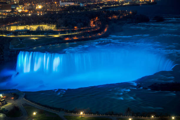 A long exposure from above of Niagara's Horseshoe Falls, on the USA/Canada border, illuminated in blue at night.