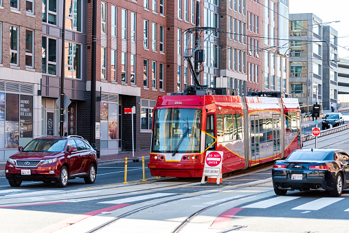 Washington DC, USA - October 12, 2018: Capital red bus Metrobus metro trolley cable car tram public transport vehicle on Capitol hill H street in city road