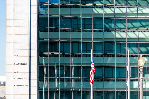 Washington DC, USA - October 12, 2018: US United States Securities and Exchange Commission SEC entrance architecture modern building sign, logo, american flag, glass windows