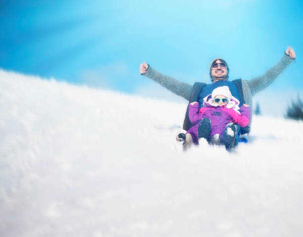 istock Father and Daughter Having Fun with the Sled 1059719382
