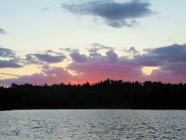istock Pink and Purple Sunset Behind the Forest 1059722664