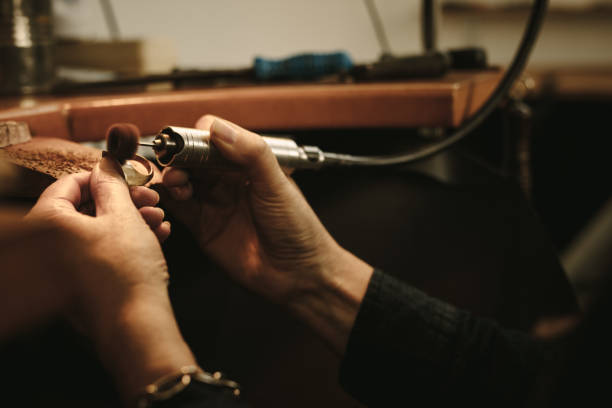 istock Jeweler polishing a gold ring at workbench 1059731444