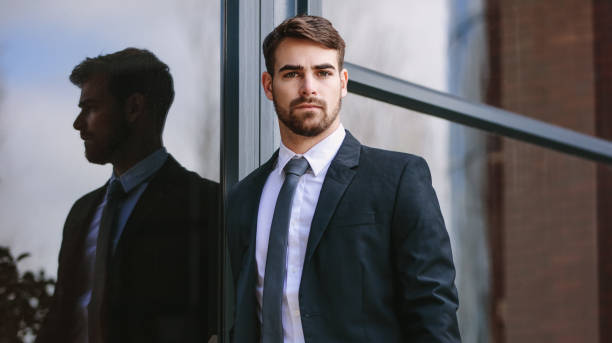 istock Businessman standing by office building outdoors 1059731632