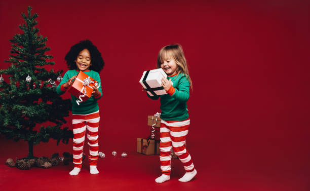 istock Happy kids looking at their gift boxes 1059733298
