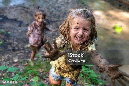 istock Smiling little muddy girl 1059735838