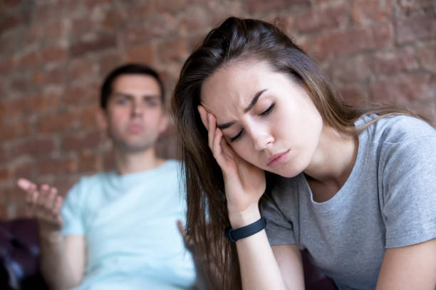 istock Offended man and woman are seated separately on sofa 1059736180