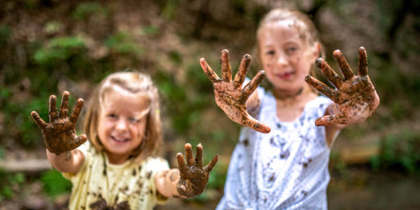 istock Smiling little muddy girls 1059737988