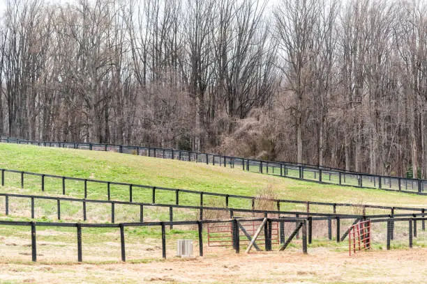 Virginia countryside in winter, autumn with brown wooden fence and farm, paddock for horses, nobody