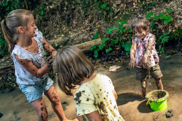 istock Three young girls making mud balls 1059738806