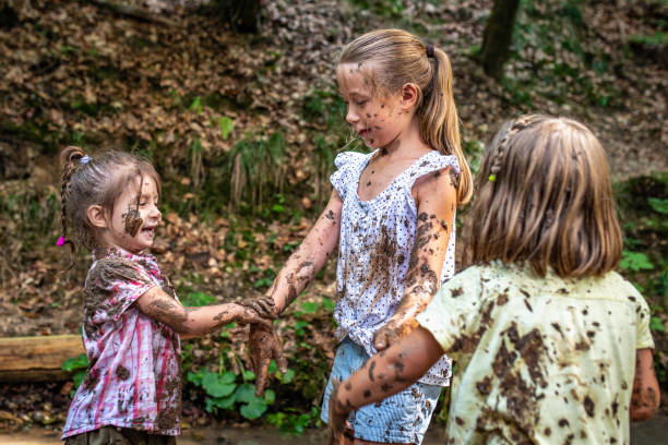 istock Three young girls playing with mud 1059740402